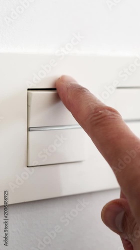 Close-up of finger switching a light off at home