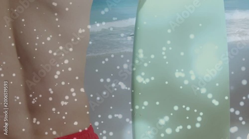 Surfer entering left, shifting right, gripping green surfboard, preparing to surf as bokeh drifts