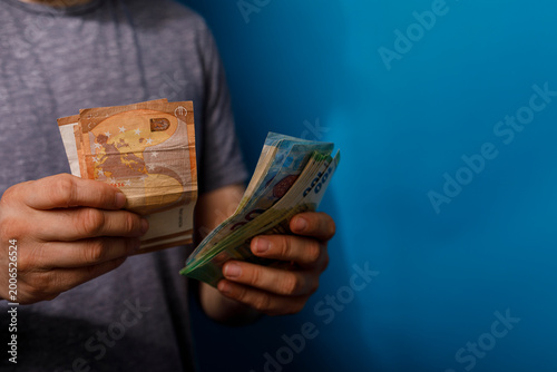Photos Person showing money, including both Euros and Turkish Lira
