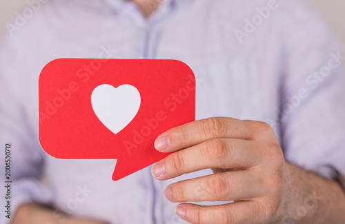 Person holding a red speech...