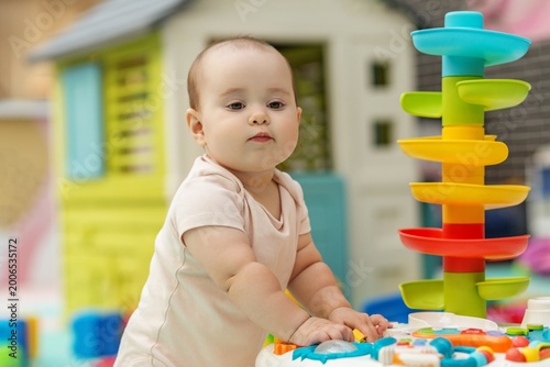Baby Playing With Educational Toy In Daycare Playroom