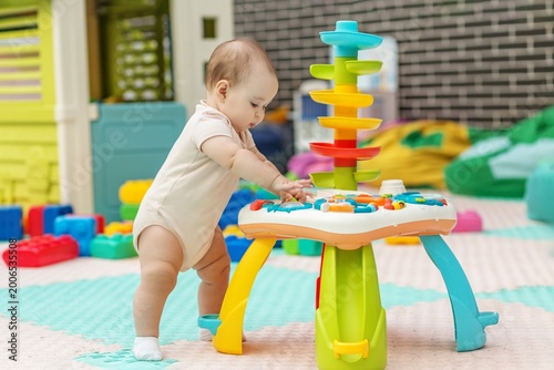 Baby Learning To Stand While Playing With Activity Table In Daycare
