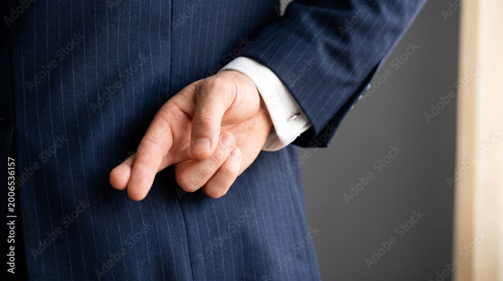 Fototapeta premium Businessman in blue suit with hand behind back