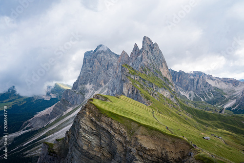 Seceda, Dolomites, Italy—lush green alpine ridge in South Tyrol under overcast sky. Scenic mountain landscape in the Alps, popular hiking and travel destination in Europe.
