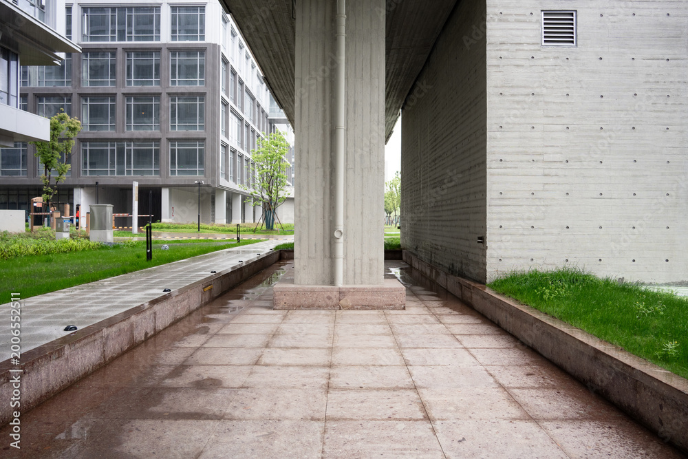 Fototapeta premium Modern architectural under-bridge concrete walkway with greenery and landscaped surroundings