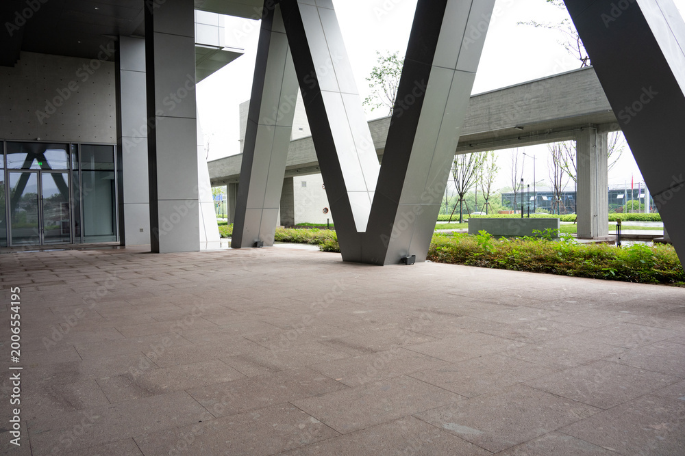 Fototapeta premium Modern architectural plaza with V-shaped metal columns and empty open space