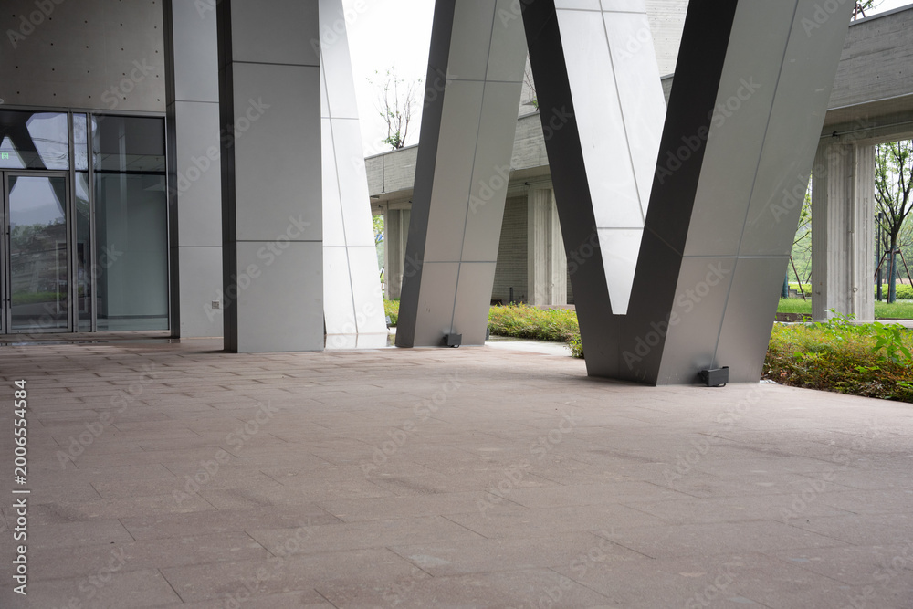Fototapeta premium Modern architectural plaza with V-shaped columns and stone pavement in outdoor urban space