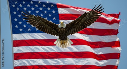 Bald eagle flying in front of american flag waving in the wind outdoors