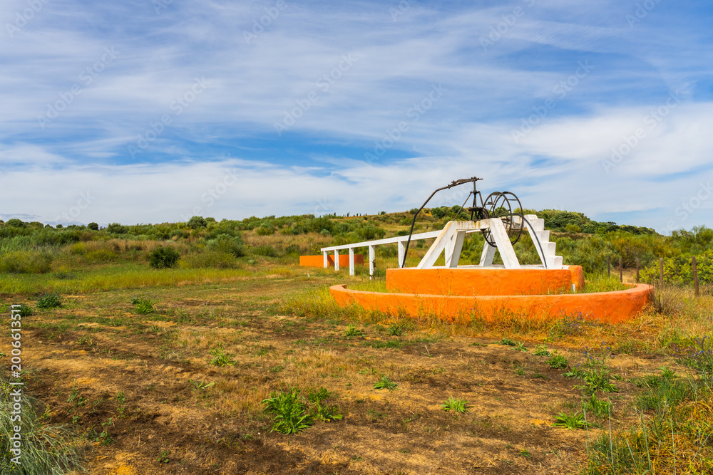 Fototapeta premium Traditional rural well in open Algarve countryside landscape