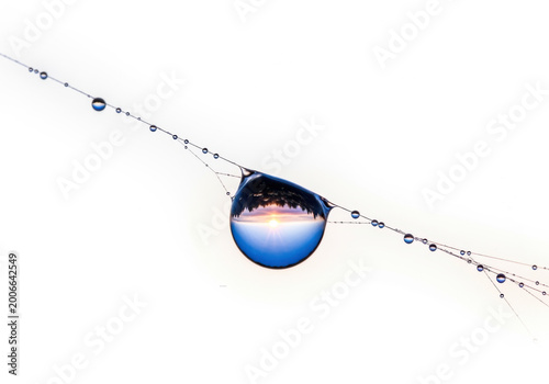 Blue round object with dotted trail in space