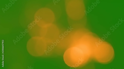 Blurry orange spots on green background.