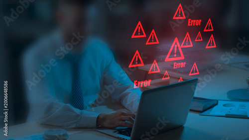 Caution failure system hacked warn alert concept. Businessman use computer laptop, triangle caution warning sign for cyber notification error, trouble maintenance. Available internet cybersecurity .