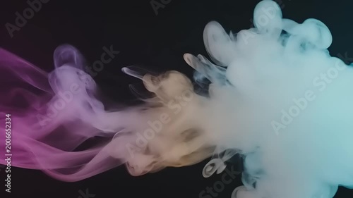 Colorful ink swirling in water closeup.