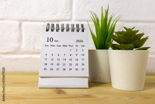Desk calendar for October 2026 on the desktop.