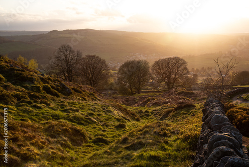 Setting Sun Shines through Trees under Curbar Edge