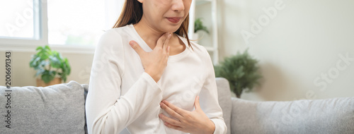 фотографія Acid reflux disease, suffer asian young woman have symptom gastroesophageal, eso