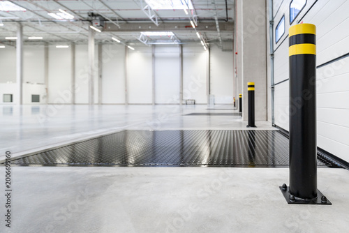 Interior of a Modern Empty Warehouse with Loading Docks and Safety Bollards