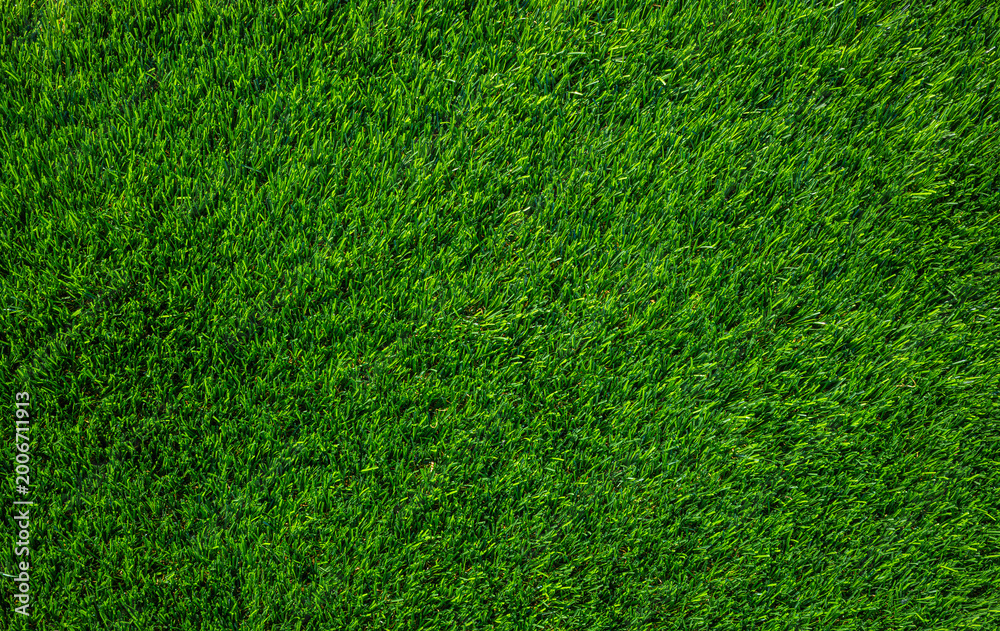 Obraz premium Bright green artificial grass lawn turf texture background