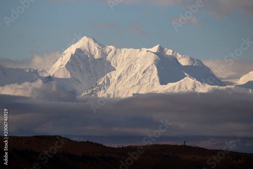 Sun shining on snowy mountain in interior Alaska