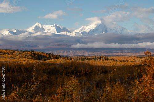Sun shining on snowy mountain in interior Alaska