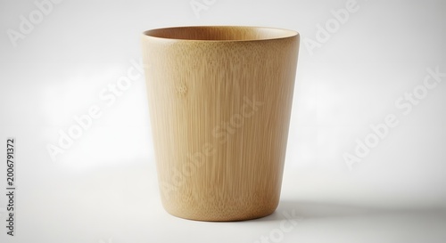 Simple wooden cup with natural bamboo texture stands elegantly isolated on a clean white background for sustainable drinkware product design photography