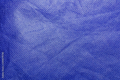 Foto Rippled Blue Nonwoven Spunbond Polypropylene Fabric Texture Background - The Rugged Texture Offers a Strong Visual Aesthetic, Suitable for Fashion Design, Mockups, Posters and Creative Projects