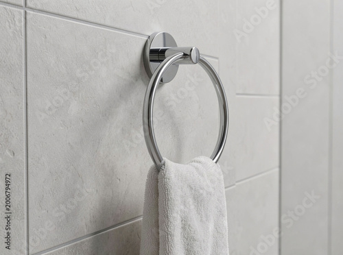 A towel hanging on a bathroom towel ring, great for travel or home use