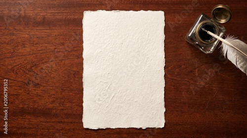 Quadro su tela Blank Handmade Paper Sheet With Quill Pen On Polished Wooden Desk