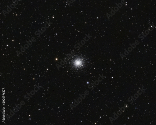 A dense globular star cluster with thousands of glowing stars is centered against the dark expanse of outer space.