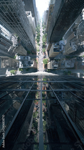 Vertical view down from skyscraper rooftop into urban street canyon between buildings