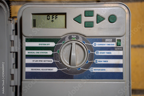 Bild auf Leinwand Close-up of irrigation controller panel showing time setting on digital display, selector dial, and buttons for automatic watering system