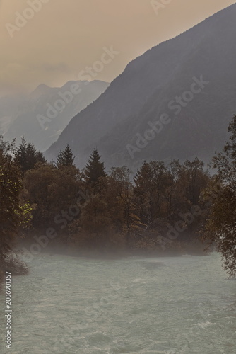 Photos Soca river green waters rush in the rain as they cross the Julian Alps, seen eastward upstream from the Za Otoki footbridge