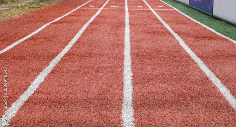 Fototapeta premium Running track lanes at stadium, perspective sports background