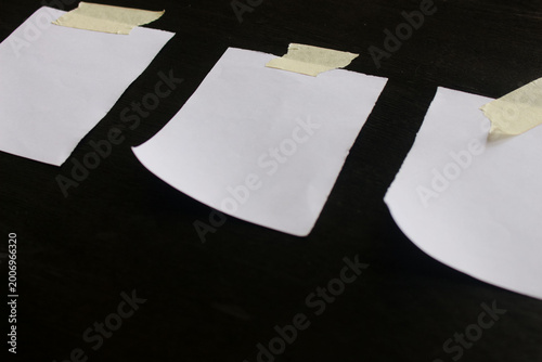 Small white paper note on black background