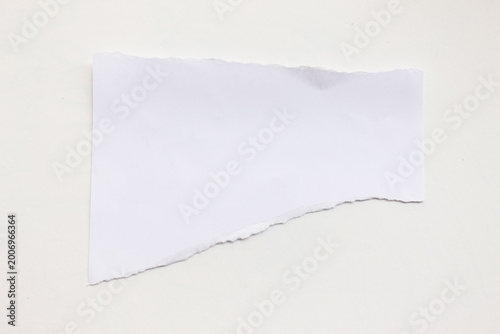 White torn paper pieces on a white background