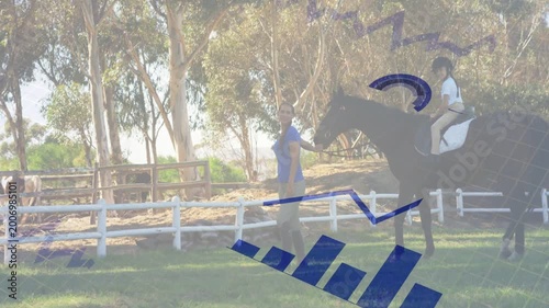 Coach leading horse with child rider in arena, blue overlay appearing over riders showing lesson