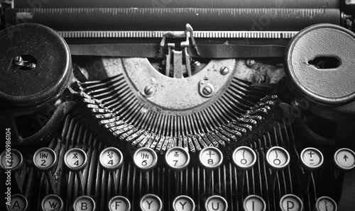 close-up of worn vintage typewriter keys, curved metal typebars, ink spools and platen conveying a nostalgic, tactile, mechanical mood