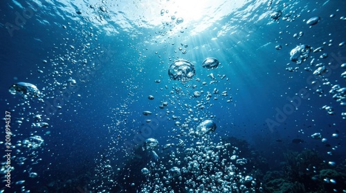 Many air bubbles under water in a deep blue ocean