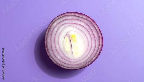 A cut red onion on purple background
