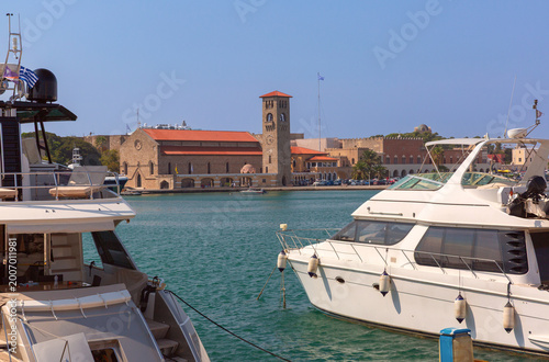 Mandraki harbor with yachts and old buildings in Rhodes Greece