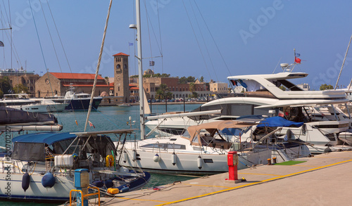 Mandraki harbor with yachts and old buildings in Rhodes Greece