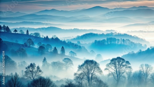 Serene Misty Mountainscape Rolling Hills Enveloped in a Soft, Blue Haze at Dawn