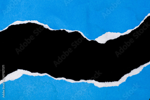 Canvas-taulu Torn paper reveals a stark black void against vivid blue