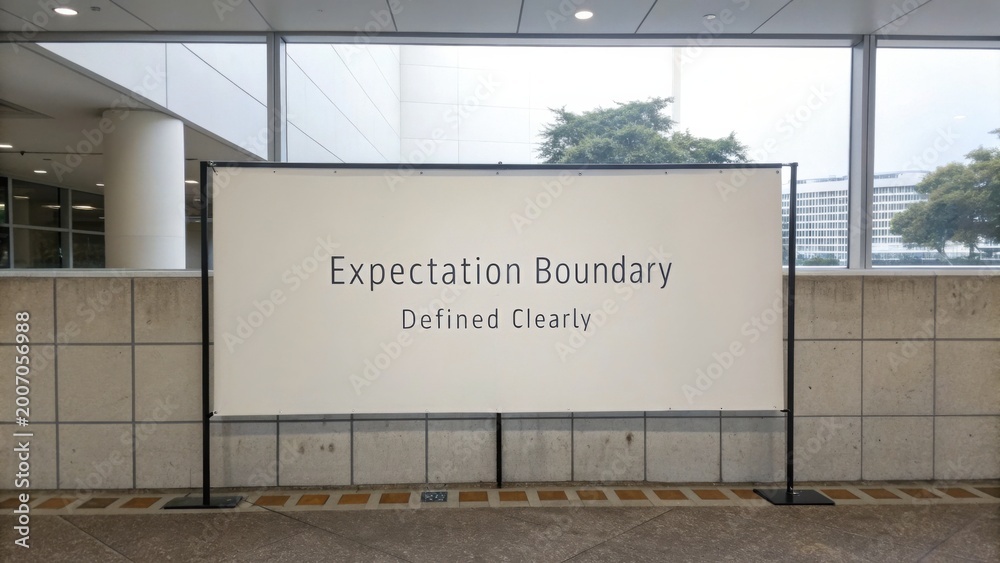 Obraz premium Clear Signage Displaying Expectation Boundary Concept in a Modern Indoor Environment with Natural Lighting and Minimalist Design Elements