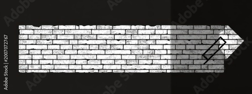 Weathered white brick arrow pointing right on black background with distressed texture and a small rectangular outline, conveying bold forward motion