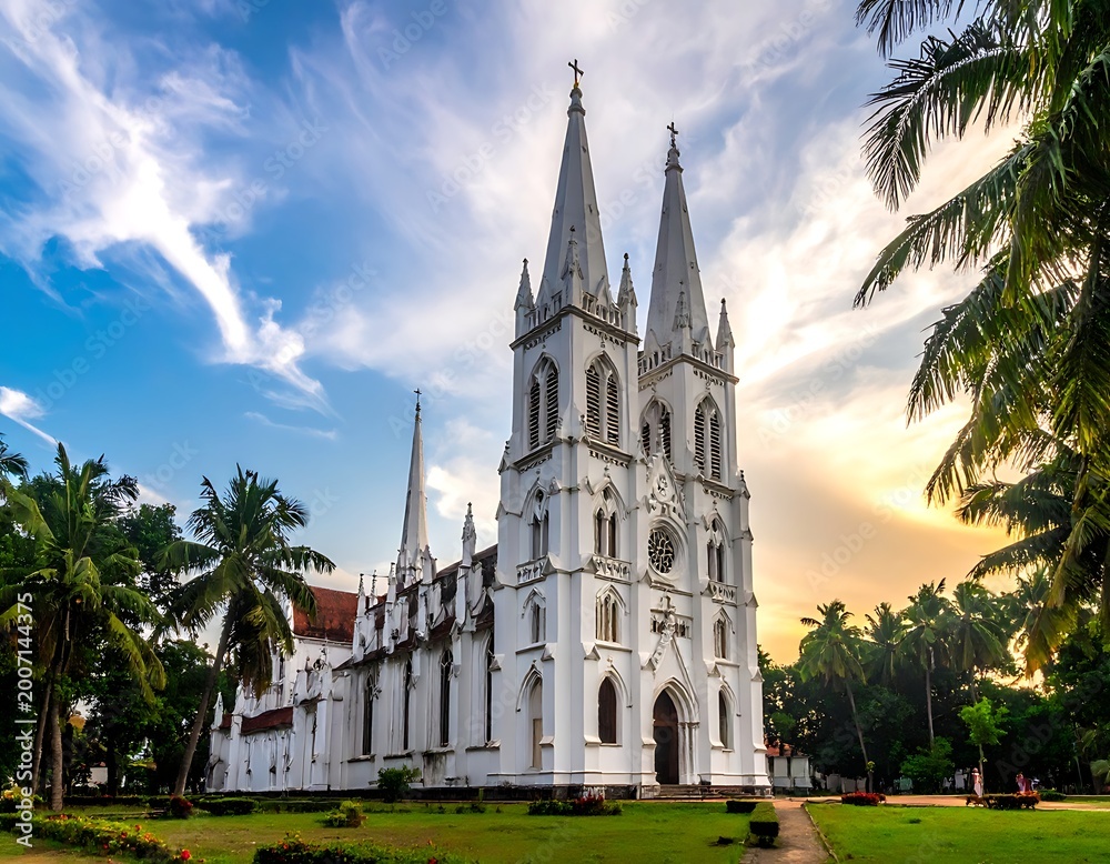 Obraz premium A large white church with two tall spires surrounded by palm trees