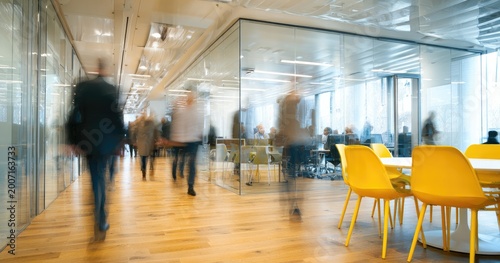 Blurred motion of people walking in a modern, bright office space
