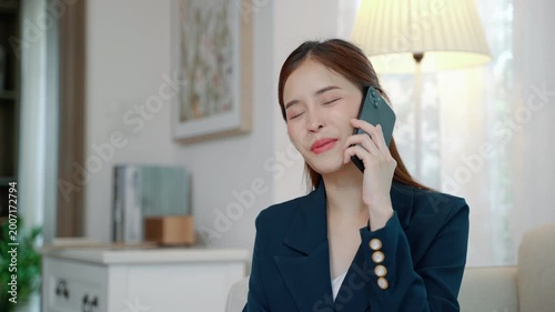 Young professional asian businesswoman using smartphone for work communication, representing remote work, entrepreneurship, and modern business lifestyle.
