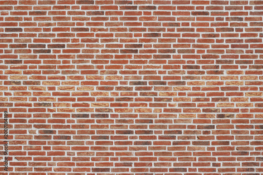 Naklejka premium Red brick wall with a textured surface featuring a variety of brick sizes and colors, creating a rustic and industrial appearance suitable for backgrounds and design projects