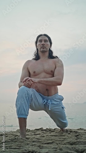 Shirtless Male Performing Lunges On Sand With Ocean Backdrop, Slow Controlled Breathing, Grounded Stance And Knee Bend, Focused Gaze, Muscular Torso, Twilight Colors And Tranquil Shoreline